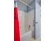 Clean bathroom with a white tiled shower and red piano-themed shower curtain at 1055 Sunshine Sw Way, Winter Haven, FL 33880