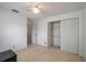 This carpeted bedroom has a ceiling fan and closet at 1055 Sunshine Sw Way, Winter Haven, FL 33880