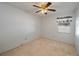 A cozy bedroom with a ceiling fan and neutral carpet at 1055 Sunshine Sw Way, Winter Haven, FL 33880