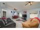 Spacious living room featuring tile floors, ceiling fans and comfortable seating area at 1055 Sunshine Sw Way, Winter Haven, FL 33880