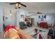 Open-concept living room and dining area with tile flooring and ceiling fans at 1055 Sunshine Sw Way, Winter Haven, FL 33880