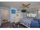 Main bedroom offers ceiling fan, slider to lanai, and dresser at 1055 Sunshine Sw Way, Winter Haven, FL 33880