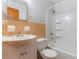 Bathroom features a tiled shower and tub, a white sink, and orange tiling at 1163 Lake Dr, Lake Wales, FL 33859