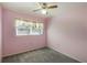 Cozy bedroom with carpeted floors and a window overlooking the surrounding landscape at 1163 Lake Dr, Lake Wales, FL 33859
