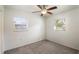 Cozy bedroom featuring carpeted floors, ceiling fan, and natural lighting from the windows at 1163 Lake Dr, Lake Wales, FL 33859