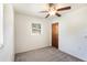 Bright bedroom with carpeted floors, ceiling fan, and a window offering natural light at 1163 Lake Dr, Lake Wales, FL 33859