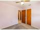 Comfortable bedroom featuring carpeted floors, ceiling fan, and two closets at 1163 Lake Dr, Lake Wales, FL 33859