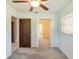Charming bedroom featuring carpeted floors, a window, and easy access to the bathroom at 1163 Lake Dr, Lake Wales, FL 33859