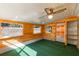 Bonus room with wood walls, green carpet, and a ceiling fan at 1163 Lake Dr, Lake Wales, FL 33859