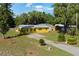 Charming yellow single-story home with a paved driveway, well-maintained lawn, and mature trees providing shade at 1163 Lake Dr, Lake Wales, FL 33859