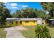 Charming single-story home features a well-maintained front lawn and a detached garage at 1163 Lake Dr, Lake Wales, FL 33859