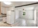 Open kitchen with white cabinets, tiled floors, and dining area creating a welcoming space at 1163 Lake Dr, Lake Wales, FL 33859