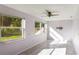 Light-filled living room boasting tile floors, large windows, and a modern ceiling fan at 1163 Lake Dr, Lake Wales, FL 33859
