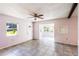Bright living room features tile floors, ceiling fan, and an abundance of natural light at 1163 Lake Dr, Lake Wales, FL 33859