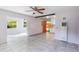 Spacious living area with tile flooring, ceiling fan, and seamless flow into other rooms at 1163 Lake Dr, Lake Wales, FL 33859