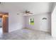 Open living space, tile flooring, fan, white walls, and ample natural light creating cozy space at 1163 Lake Dr, Lake Wales, FL 33859