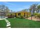 Spacious backyard featuring well-maintained lawn, mature trees, a fenced area, and a screened-in pool at 1226 Lake Loop, Winter Haven, FL 33880
