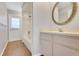 Bright bathroom features a tub and a shower and a white vanity with a decorative mirror at 1226 Lake Loop, Winter Haven, FL 33880