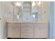 Dual vanity bathroom with ample cabinet space and decorative mirrors at 1226 Lake Loop, Winter Haven, FL 33880