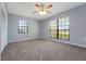 Well-lit bedroom featuring a ceiling fan and two windows for ample natural light at 1226 Lake Loop, Winter Haven, FL 33880