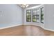 Bright dining area with wood-look tile floors, large windows, and modern light fixture at 1226 Lake Loop, Winter Haven, FL 33880