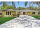 Charming single-story home with a long driveway, stone accents, manicured lawn and mature landscaping at 1226 Lake Loop, Winter Haven, FL 33880