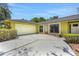 Attached two-car garage featuring a modern door and concrete driveway providing ample parking space at 1226 Lake Loop, Winter Haven, FL 33880