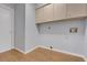 Neutral laundry room with tile flooring, storage cabinets, and washer/dryer hookups at 1226 Lake Loop, Winter Haven, FL 33880