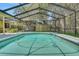 Relax in the refreshing pool with a screened enclosure and a charming backyard at 1226 Lake Loop, Winter Haven, FL 33880