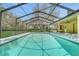 Enjoy a refreshing swim in your screened in pool surrounded by lush landscaping at 1226 Lake Loop, Winter Haven, FL 33880
