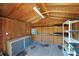 Interior view of the backyard shed, showcasing storage shelves and a workbench at 1226 Lake Loop, Winter Haven, FL 33880