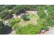 Expansive aerial view of a wooded lot with mature trees and single-Gathering home and outlined with a red boundary line at 1294 1/2 38Th Nw St, Winter Haven, FL 33881