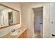 Bathroom vanity and mirror, with doorway to another room at 1294 1/2 38Th Nw St, Winter Haven, FL 33881
