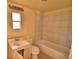 Bathroom with a combination tub and shower, vanity, and a window at 1294 1/2 38Th Nw St, Winter Haven, FL 33881
