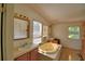 Bathroom featuring a unique standalone tub, sink and vanity area, and light fixtures, offering comfort and functionality at 1294 1/2 38Th Nw St, Winter Haven, FL 33881