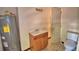 Bathroom featuring a vanity with a single sink, toilet, and hot water heater at 1294 1/2 38Th Nw St, Winter Haven, FL 33881