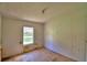 View of an empty bedroom with light walls and a ceiling fan hanging, along with windows providing natural light at 1294 1/2 38Th Nw St, Winter Haven, FL 33881