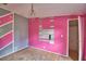 Pink bedroom with chandelier and decorative wall at 1294 1/2 38Th Nw St, Winter Haven, FL 33881