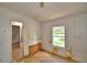 Bedroom featuring a window view and doorway with exposed wall and floor needing repair at 1294 1/2 38Th Nw St, Winter Haven, FL 33881