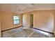 Bedroom view featuring window and entry door within peach colored interior at 1294 1/2 38Th Nw St, Winter Haven, FL 33881
