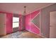 Pink bedroom with chandelier and decorative wall at 1294 1/2 38Th Nw St, Winter Haven, FL 33881