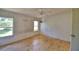 View of an empty bedroom with light walls and a ceiling fan hanging, along with windows providing natural light at 1294 1/2 38Th Nw St, Winter Haven, FL 33881