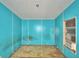 View of bedroom with blue walls, window air conditioning unit and damaged flooring at 1294 1/2 38Th Nw St, Winter Haven, FL 33881