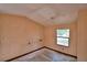 Empty bedroom showing a single window within a peach colored interior at 1294 1/2 38Th Nw St, Winter Haven, FL 33881