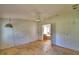 View of an empty bedroom with light walls and a ceiling fan hanging, along with windows providing natural light at 1294 1/2 38Th Nw St, Winter Haven, FL 33881
