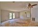 Bedroom featuring a ceiling fan, and double doors offering natural light, with a glimpse into the next room at 1294 1/2 38Th Nw St, Winter Haven, FL 33881