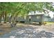 Exterior view of a home with trees, and stairs at 1294 1/2 38Th Nw St, Winter Haven, FL 33881