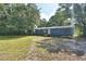 Exterior elevation of a blue single-story home surrounded by trees at 1294 1/2 38Th Nw St, Winter Haven, FL 33881