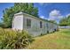 Exterior view of a home with light siding and landscaping at 1294 1/2 38Th Nw St, Winter Haven, FL 33881
