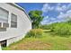 A home exterior with light siding and a grassy yard and green trees at 1294 1/2 38Th Nw St, Winter Haven, FL 33881